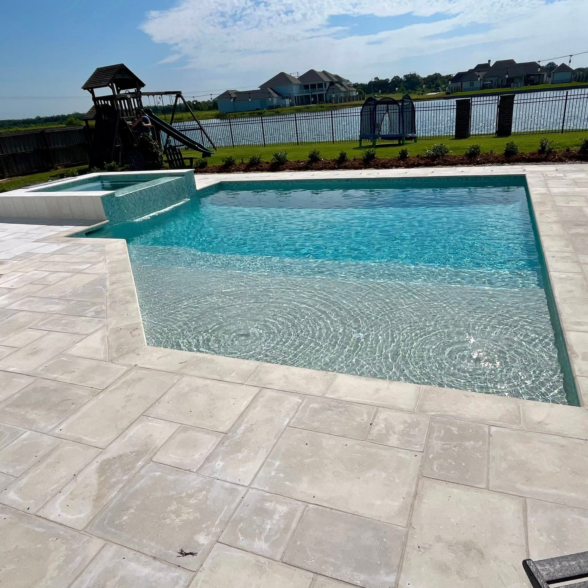 Beautiful pool with travertine coping and water view